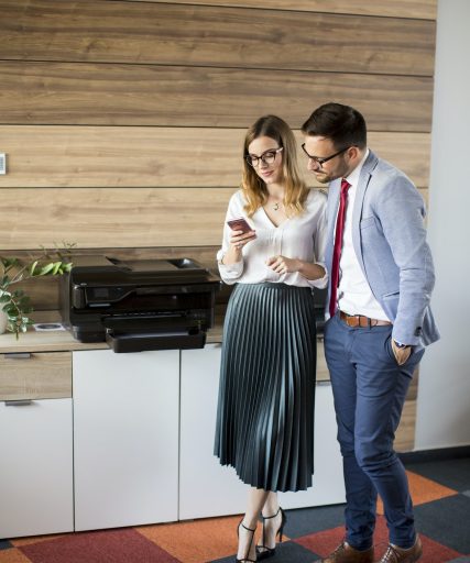 business-people-talking-in-office-by-the-scanner-mashine.jpg